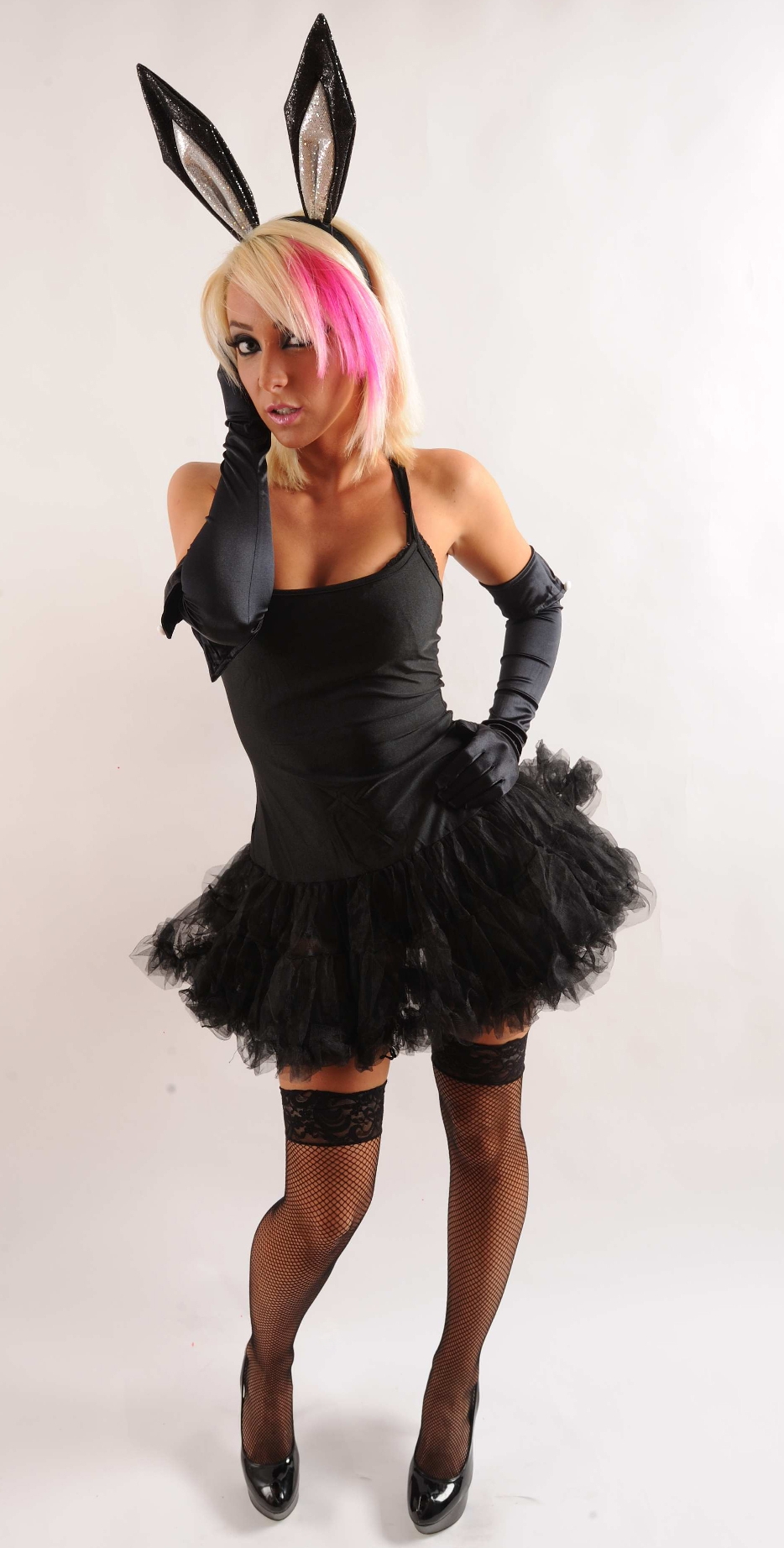 Blonde Bunny Girl wearing Black Stay-Up Fishnet Stockings, Satin Gloves and Black Short Dress